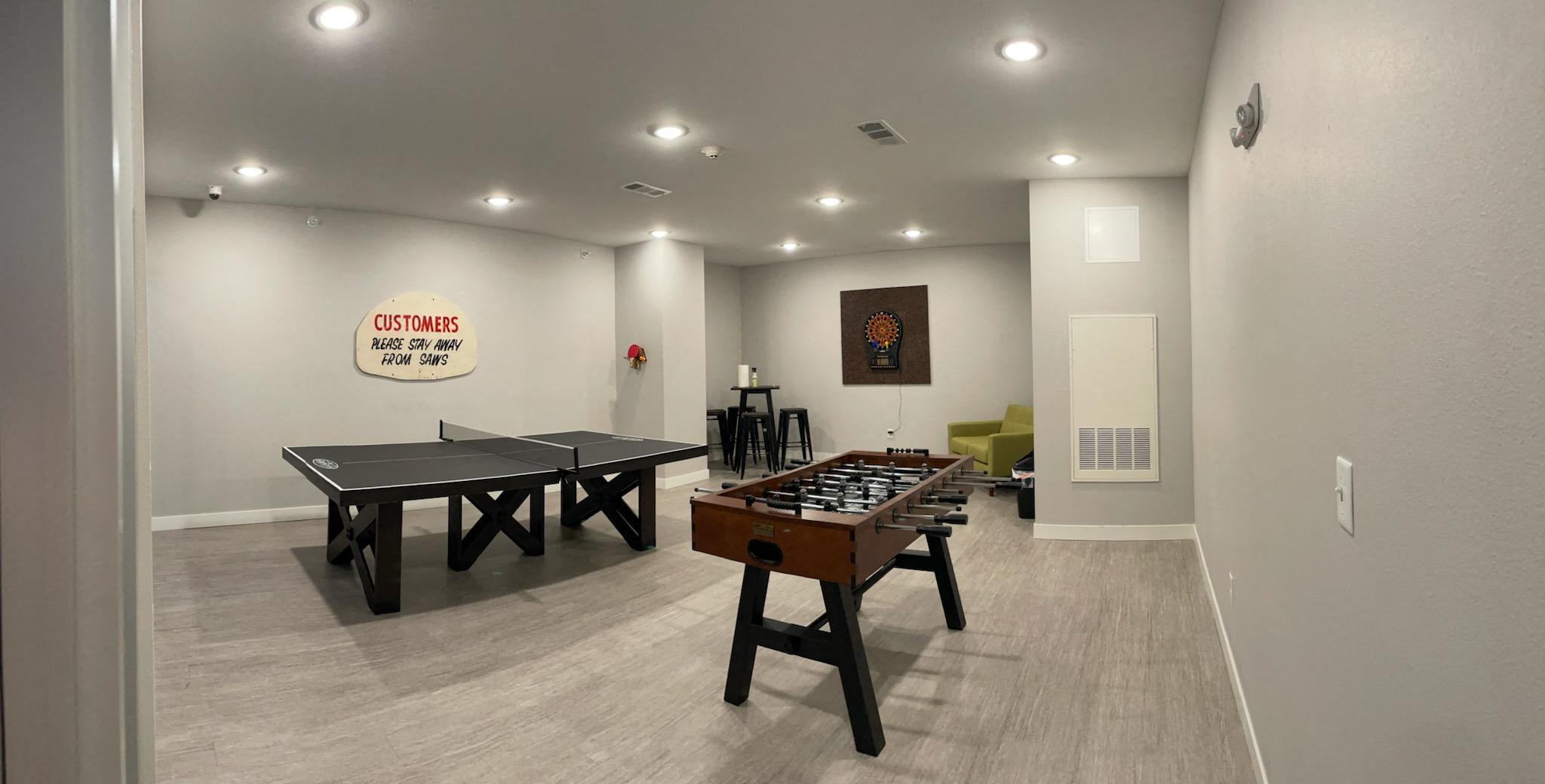 a games room with ping pong tables and a foosball table